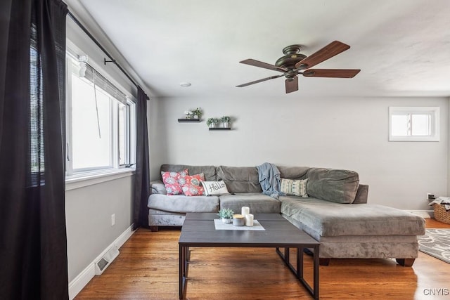 living room featuring hardwood / wood-style flooring and ceiling fan