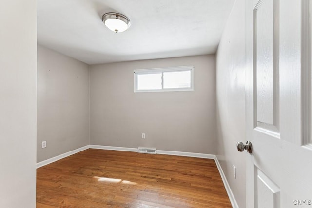 spare room with hardwood / wood-style floors