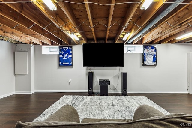 living room featuring a healthy amount of sunlight and dark hardwood / wood-style flooring