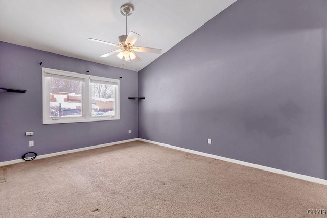 empty room with carpet floors, vaulted ceiling, and ceiling fan