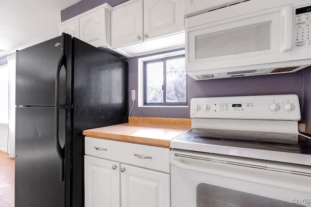 kitchen with white cabinetry and white appliances