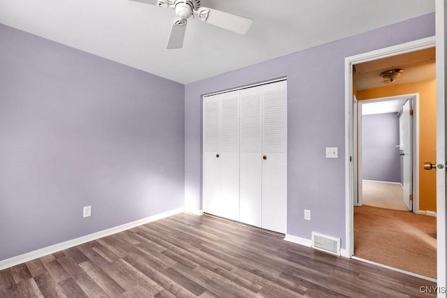 unfurnished bedroom featuring hardwood / wood-style flooring, ceiling fan, and a closet