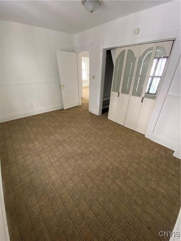 unfurnished bedroom with a closet