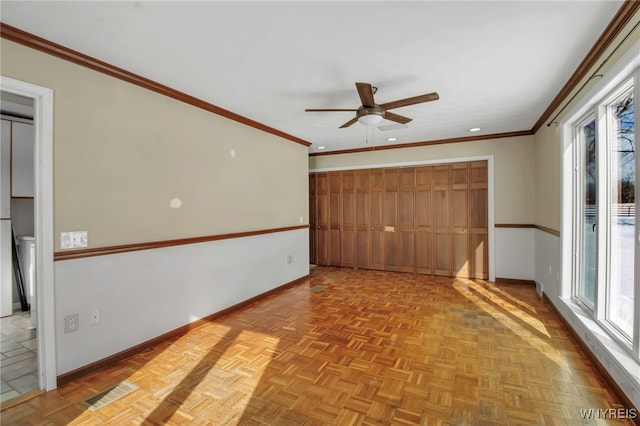 unfurnished room featuring ceiling fan, ornamental molding, and light parquet floors