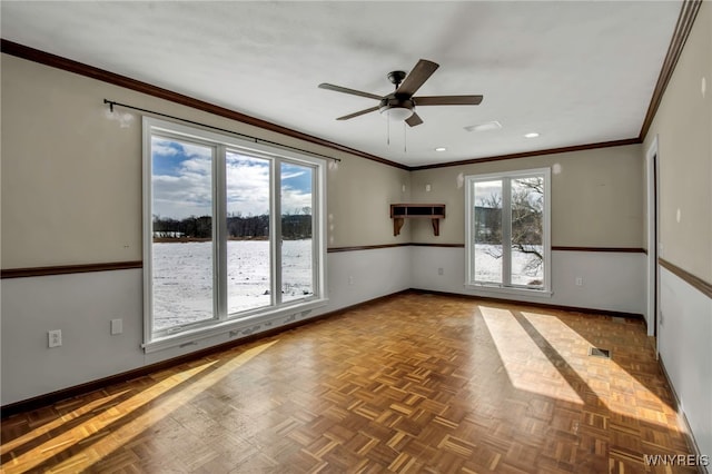 empty room featuring ornamental molding, parquet floors, and plenty of natural light