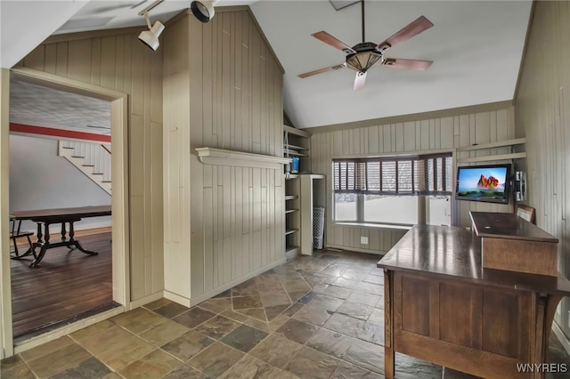 office area with high vaulted ceiling, wood walls, and ceiling fan