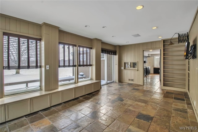 interior space featuring wooden walls