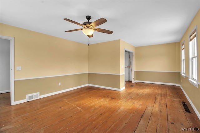 spare room with hardwood / wood-style floors and ceiling fan