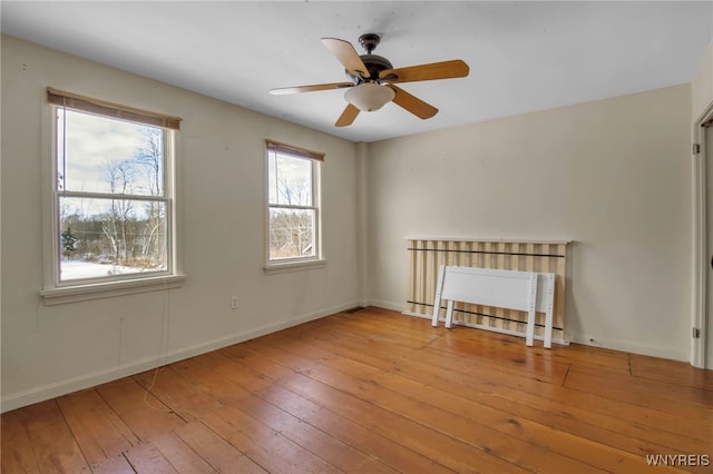 spare room with ceiling fan and light hardwood / wood-style flooring