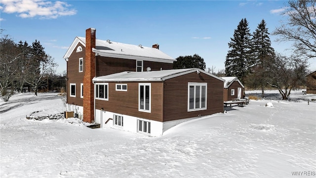 view of snow covered back of property