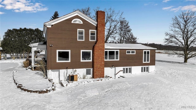 view of snow covered rear of property