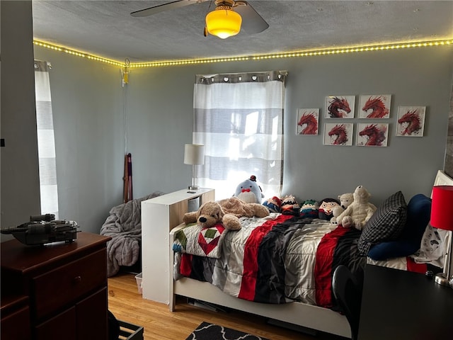 146 N Broad St, Norwich-City, NY 13815 - bedroom featuring light hardwood / wood-style floors, ceiling fan, and a textured ceiling