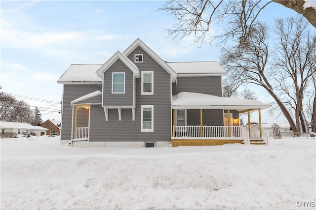 snow covered house with a porch