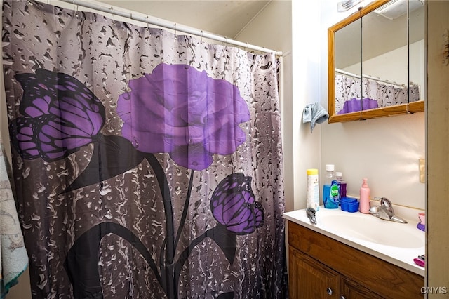 bathroom with vanity and curtained shower