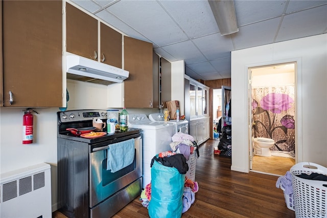 kitchen featuring stainless steel electric range, radiator heating unit, a drop ceiling, independent washer and dryer, and dark hardwood / wood-style floors