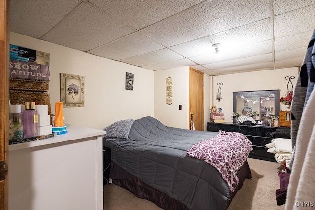 bedroom featuring carpet flooring and a paneled ceiling