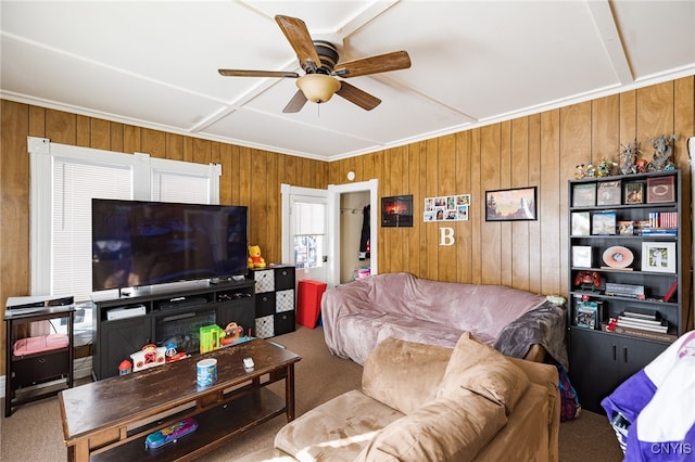 living room featuring ceiling fan, carpet flooring, and wood walls