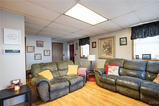 living room with hardwood / wood-style flooring and a drop ceiling