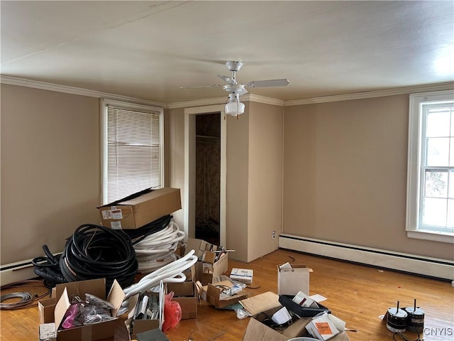 miscellaneous room featuring a baseboard radiator, ornamental molding, ceiling fan, and light hardwood / wood-style floors