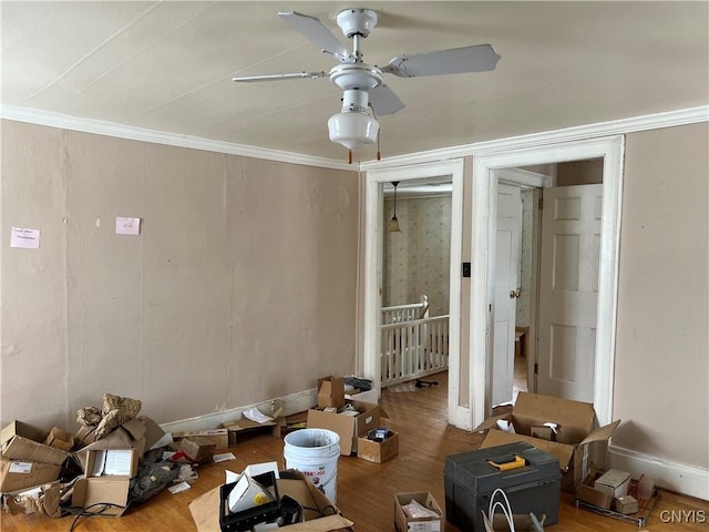 living room with ornamental molding, ceiling fan, and wood-type flooring