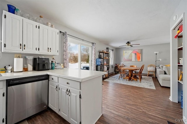 kitchen with dishwasher, white cabinets, ceiling fan, dark hardwood / wood-style floors, and kitchen peninsula