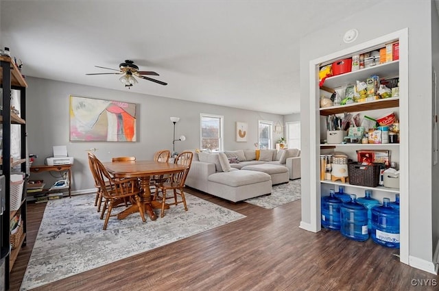 dining area with ceiling fan and dark hardwood / wood-style flooring