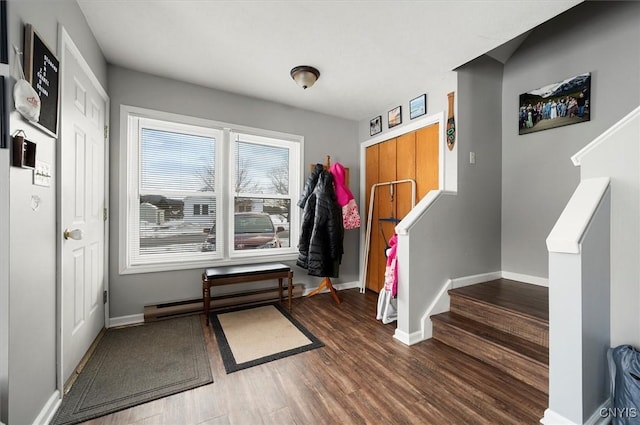 interior space featuring wood-type flooring and a baseboard heating unit