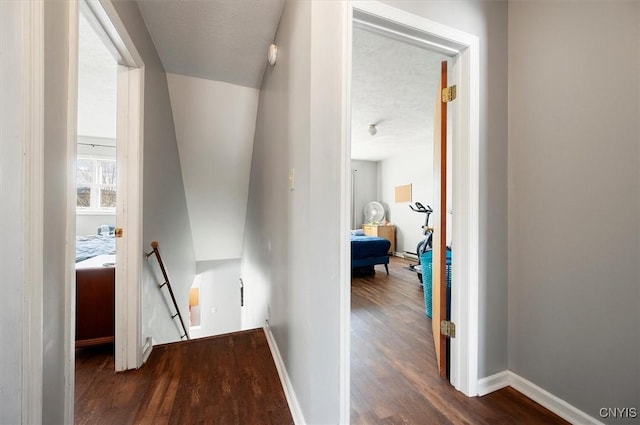 hall featuring dark hardwood / wood-style flooring and a textured ceiling