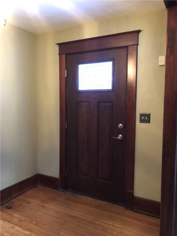 entryway featuring light wood-type flooring and baseboards