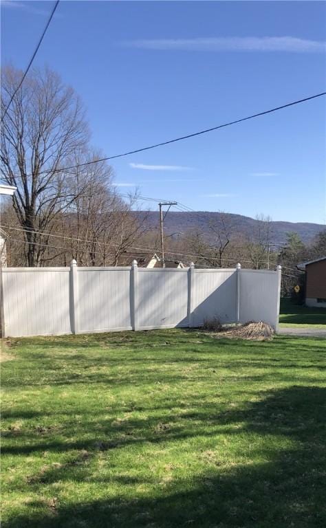 view of yard with fence and a mountain view