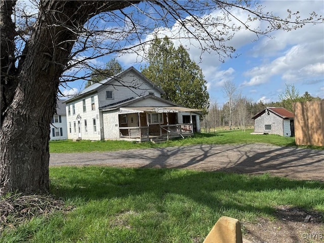 exterior space with a yard and covered porch