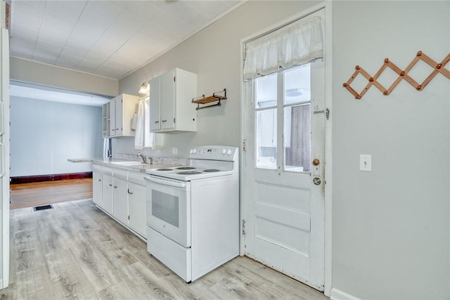 kitchen with sink, light wood-type flooring, white cabinetry, and white electric range