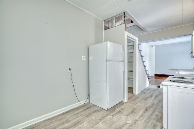 kitchen with white appliances, light hardwood / wood-style flooring, and white cabinets