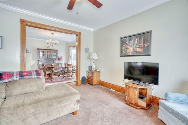 living room with ceiling fan with notable chandelier, crown molding, and carpet