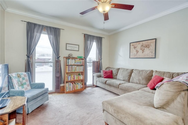 living room featuring carpet floors, ornamental molding, and ceiling fan