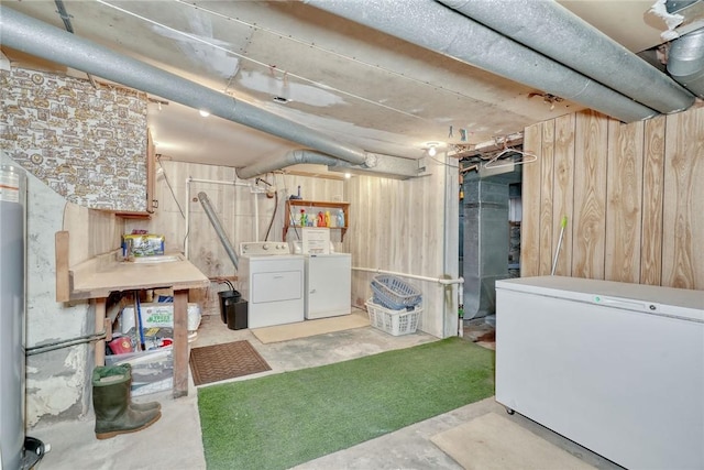 basement with refrigerator, washing machine and dryer, and wooden walls