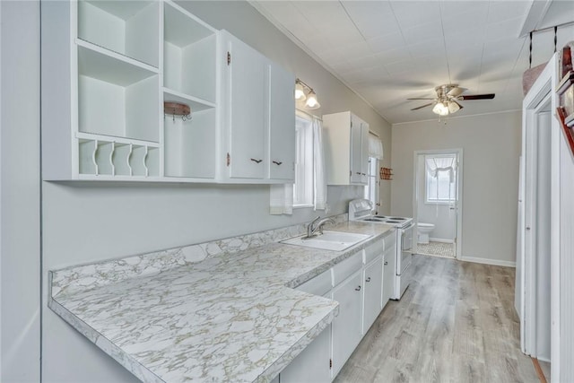 kitchen featuring white cabinetry, light wood-type flooring, electric stove, and sink