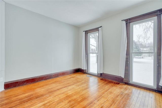 unfurnished room featuring hardwood / wood-style floors