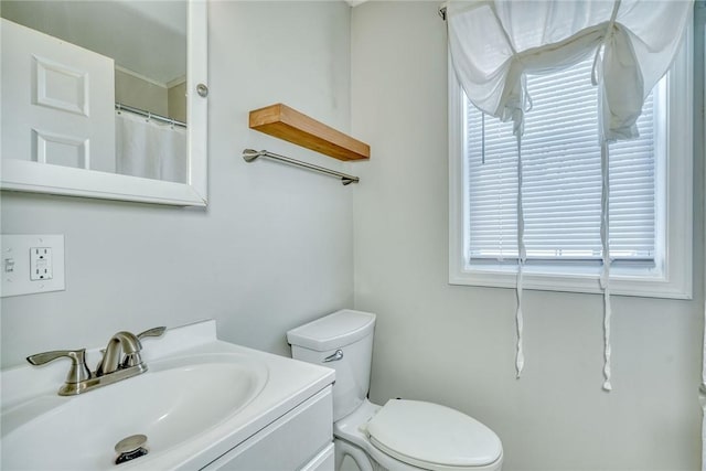 bathroom featuring toilet and vanity