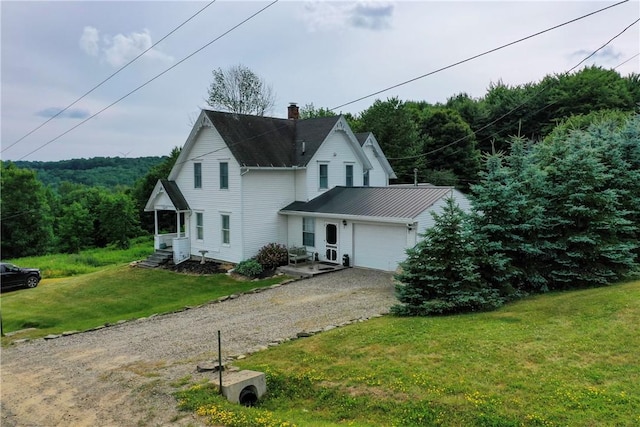 view of front of property featuring a garage and a front lawn