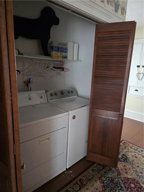 washroom featuring dark hardwood / wood-style flooring and washing machine and dryer