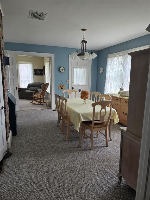 dining area with dark colored carpet