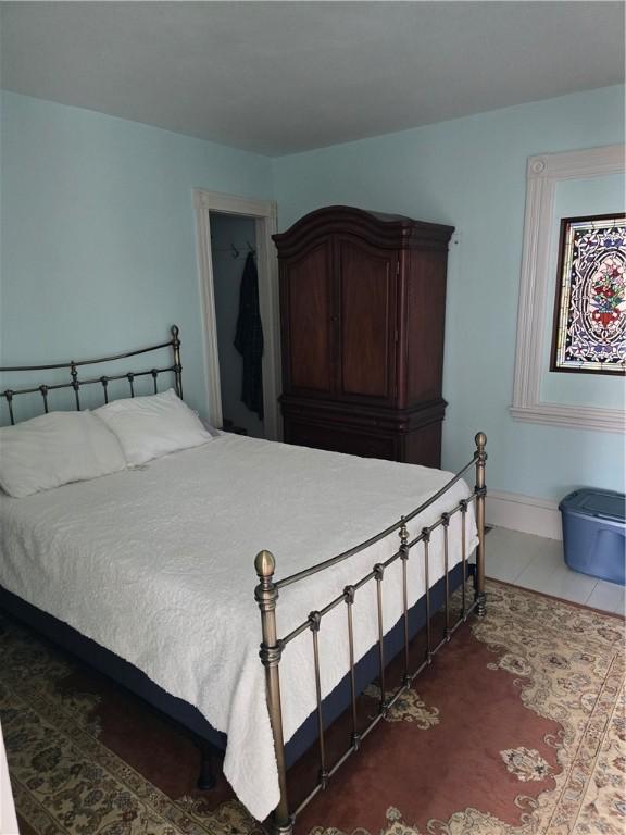 bedroom with dark tile patterned floors