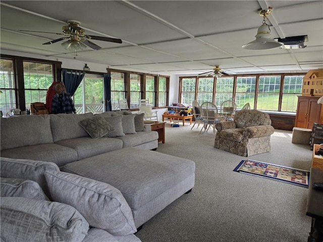 living room with ceiling fan and carpet