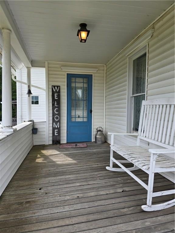 wooden terrace featuring covered porch