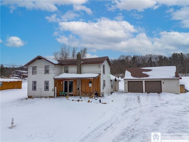 snow covered property featuring a garage