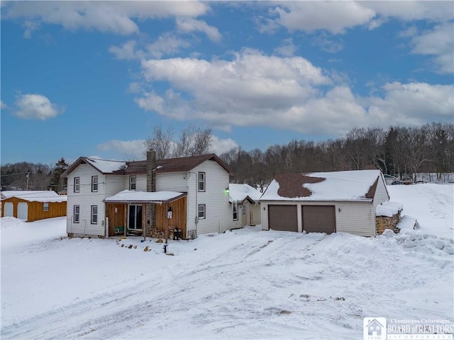 view of snow covered rear of property