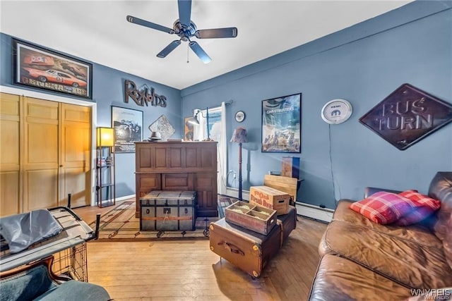 bedroom featuring ceiling fan, wood-type flooring, and baseboard heating