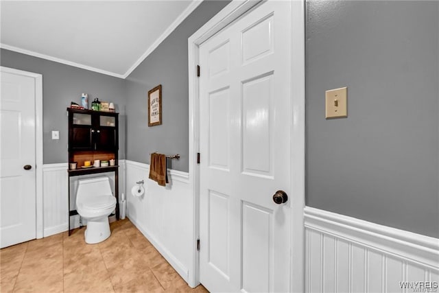 bathroom featuring ornamental molding, tile patterned flooring, and toilet