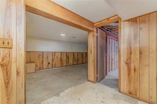 basement featuring wooden walls